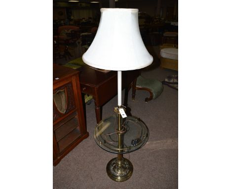 A brass standard lamp, with silk shade and glass table mount.