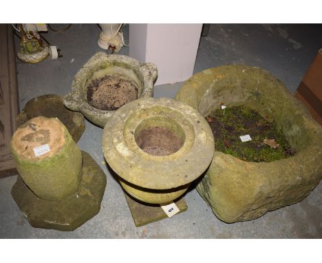 A sand stone garden trough; a garden urn; a carved stone planter; and a stone bird bath.