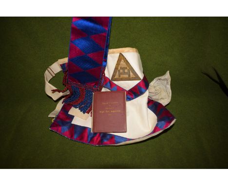 A Masonic apron and sash; and a small booklet on The Royal Ark Masons General Regulations.