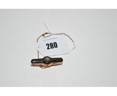 An onyx and seed pearl set yellow metal mourning brooch, stamped '9ct.'.