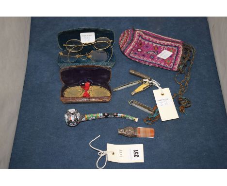 An early 20th Century white metal and banded agate whistle; a Middle Eastern style enamel pipe; two mother-of-pearl pen knive