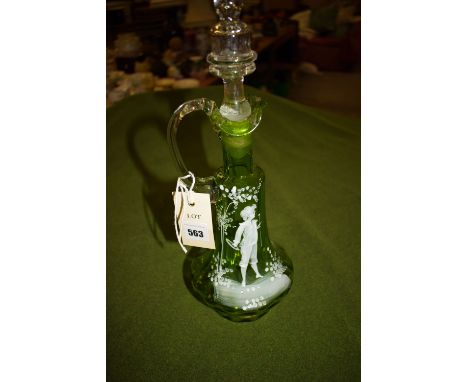 A late 19th Century Mary Gregory style green glass claret jug, white enamel decoration of a boy amongst foliage, clear stoppe