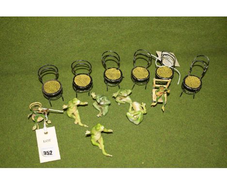 Two cold painted metal frogs sitting on chairs with musical instruments; together with five ceramic frogs (one missing), seat