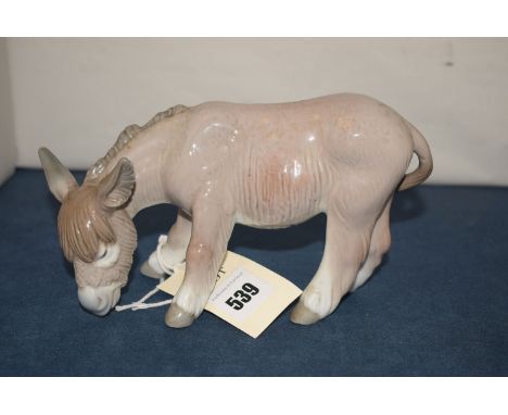 A ceramic model of a donkey by Lladro.
