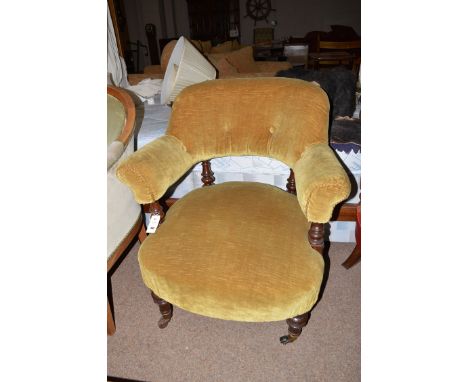 A Victorian easy chair with upholstered back, arms and seat raised on turned legs, terminating in ceramic castors.