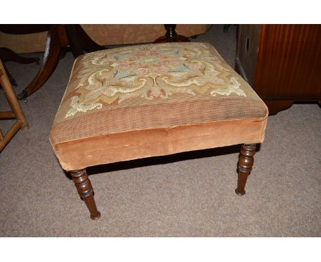 A 19th Century square stool with woolwork tapestry seat, raised on turned legs.