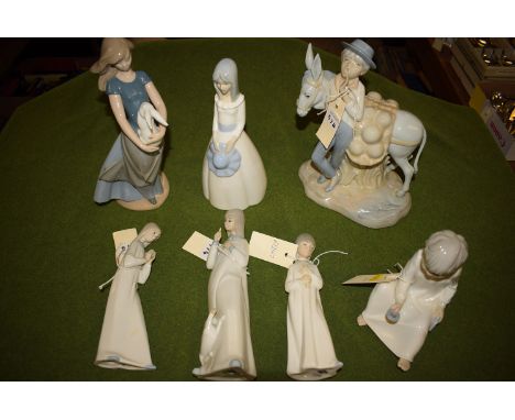 Four Spanish figurines, one of a girl with a donkey and three Nao figurines.  (7)