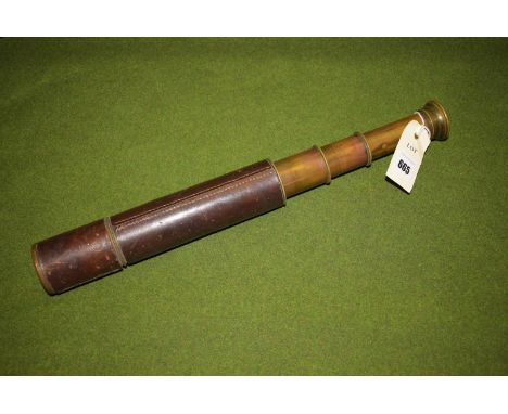 A three drawer brass telescope bound in leather by Broadhurst Clarkson and Co., London, x 25 magnification.