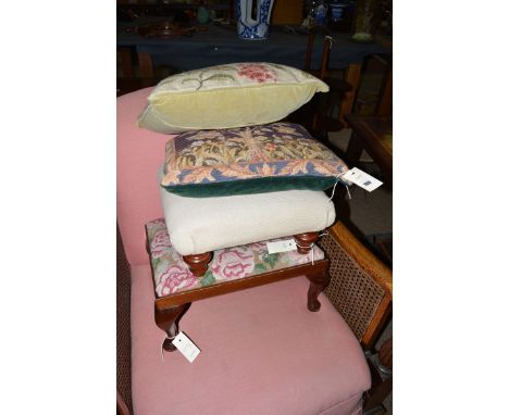 Two woollen tapestry cushions; together with two footstools.