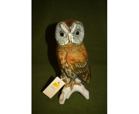 A Continental ceramic figure of an owl perched on a tree stump, marked to base no. 7575.