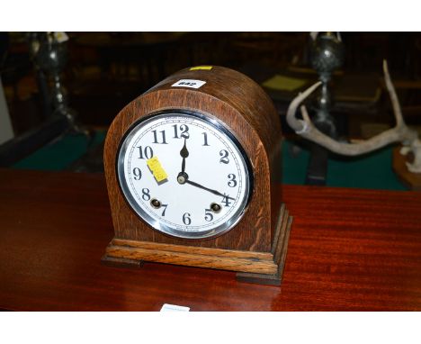 An oak cased mantel clock by Garrard Ltd.