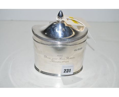A silver tea caddy, by W. & S., Sheffield 1918, of oval form, with domed cover and presentation inscription.