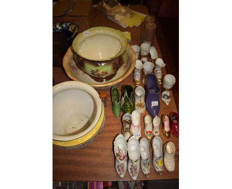 Two early 20th Century jardinieres; a wash bowl; together with a collection of ceramic boots and shoes.