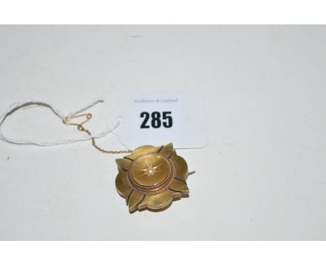 A 19th Century mourning brooch set half pearl to centre, stamped '15c., HG & S'.