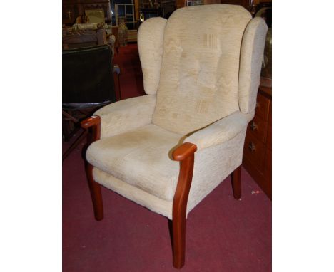 A pair of contemporary beech framed and cream floral fabric upholstered button back winged armchairs, width 72cm
