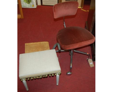 A mid-20th century tubular chrome and upholstered padback and seat swivel adjustable desk chair, raised on integral roller ca