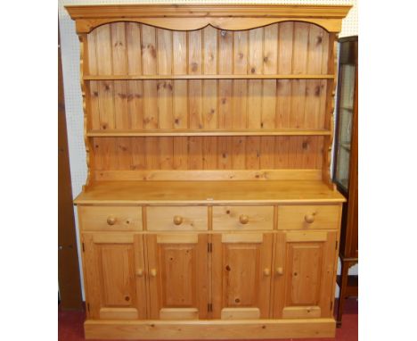 A modern pine round cornered Welsh dresser, the two-tier open plate rack over four frieze drawers to conforming recessed pane