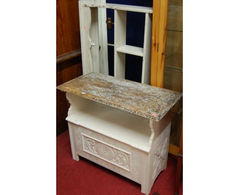 An early 20th century and later white painted line carved oak monks bench, having fold-over top and typical hinged box seat b