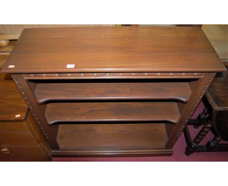 A contemporary Ercol mid-elm low freestanding open bookshelf, w.96cm