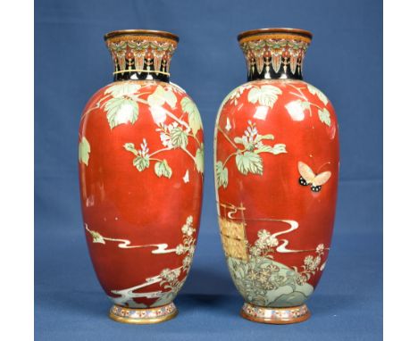 A pair of Japanese red ground cloisonné vases Meiji period (1868-1912), unmarked, of slender ovoid form with waisted neck, th