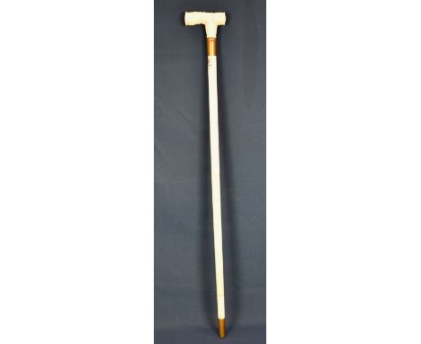 An antique style walking stick the T-handle finely carved with flowers, beneath, an engraved coat of arms, name and dated, br