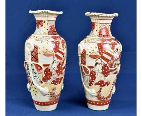 A pair of Japanese 'Kyoto' Satsuma vases 1920s-30s, richly decorated with figures in a traditional dress, having applied ring