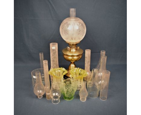 A brass oil lamp with frosted glass shade, 22½in. high together with 14 x clear glass oil lamp funnels, together with three c