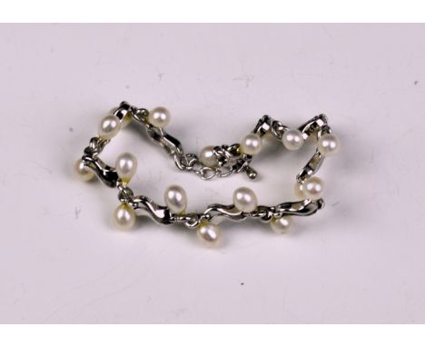 A sterling silver and seed pearl bracelet.  