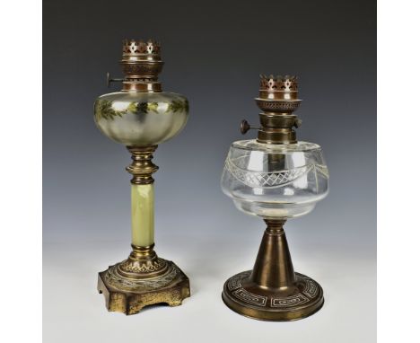 A Victorian gilt metal and alabaster oil lamp the frosted glass reservoir painted with foliage and berries, overall height 15