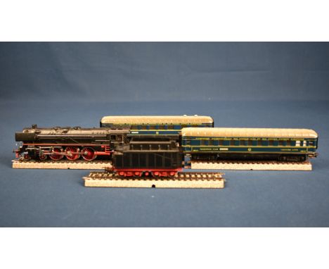 A Marklin H0 gauge locomotive and tender 01097 F800 and dining car 346/2J, sleeping car 346/3J and four pieces of track.  