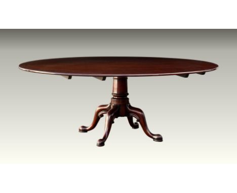 A large, good quality Georgian style mahogany single pedestal dining table fourth quarter 20th century, the oval top on a sub