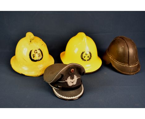 A Hendry of Glasgow leather fire helmet plus two Guernsey fire helmets, dated 1974 and 1988 and a West German air force offic