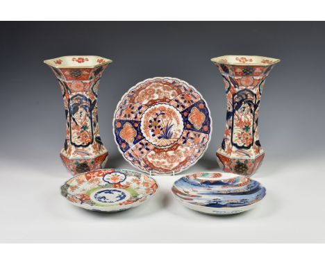 A pair of Japanese Imari trumpet vases late 19th century, of waisted, hexagonal form, painted in the typical palette with ho-