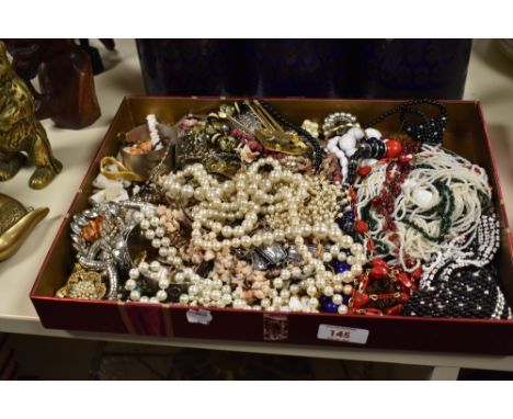 A large collection of costume jewellery, including beaded necklaces, a Mexican silver bangle, statement pieces, a silver lock