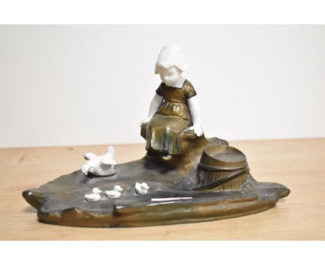 An Ernest Justin Ferrand , 1856-1932 Art Deco ink stand, having cast metal and porcelain depiction of a young girl with hen a