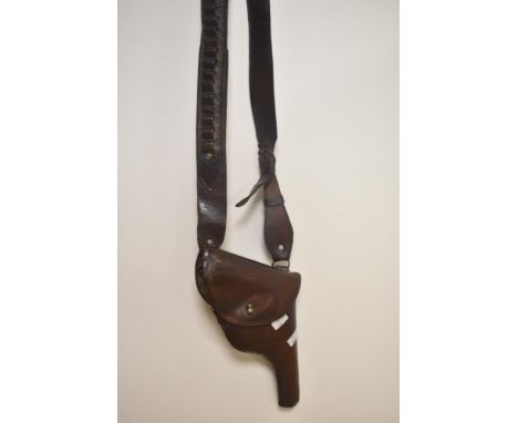 An early 20th Century brown leather gun holster and ammunition belt