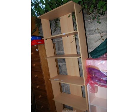 A shelf unit having four shelves  27" wide x 11" depth x 6' high.