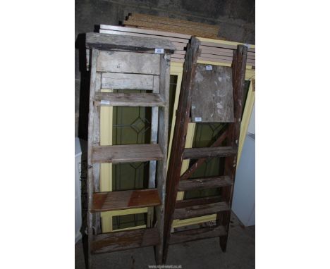 Two five rung wooden step ladders.