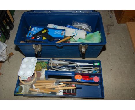 A plastic tool box with art equipment, to include: glue gun, soldering gun, paints, etc.