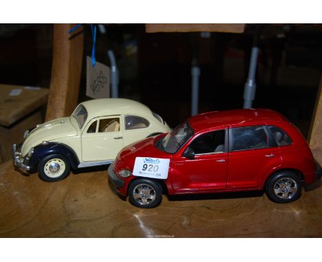 A VW Beetle model car and a Daimler Chrysler toy car, scale 1/18.
