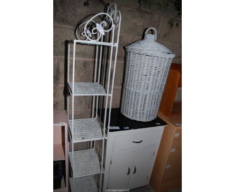 A small cupboard with glass top, a wicker bin as shelf unit.