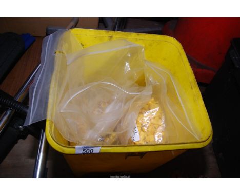 A tub of yellow insulated spade connectors and ring connectors.