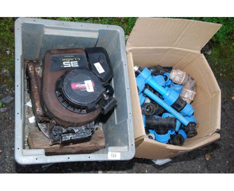A Briggs & Stratton 4 stroke petrol engine and pipe connectors.