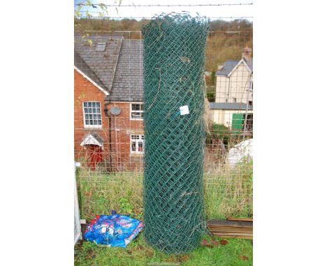 A roll of chain link fencing, fencing 6' high.