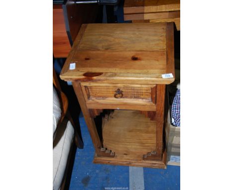 A lightwood bedside table with frieze drawer and lower shelf, 17" wide x 15 1/2" depth x 28" high.