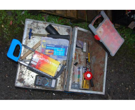 A metal trunk containing screws, hammers, wire connectors etc.