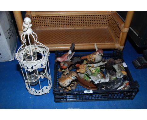 A candle lantern and bird ornaments.
