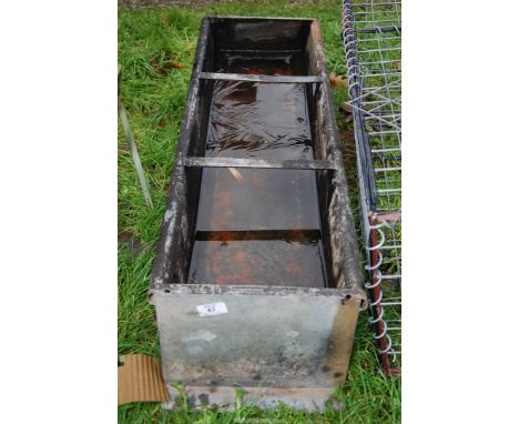 A small galvanized feed trough, 3' long x 12" depth x 8" high.