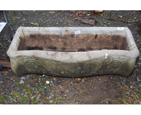 A long concrete planter on plinth, 29" wide x 12" deep x 8" high.