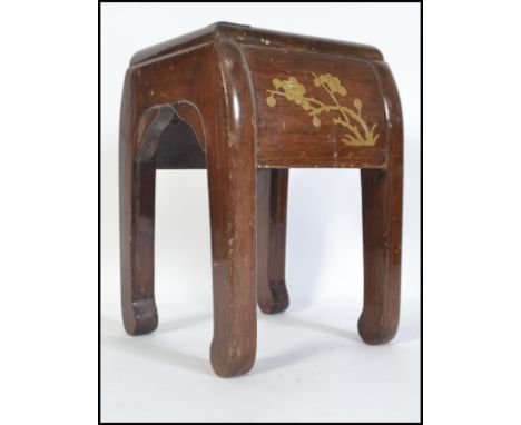 A Chinese wood stool of quatrefoil form, decorated with gourds and peony flowers in coloured lacquer on&nbsp;black ground